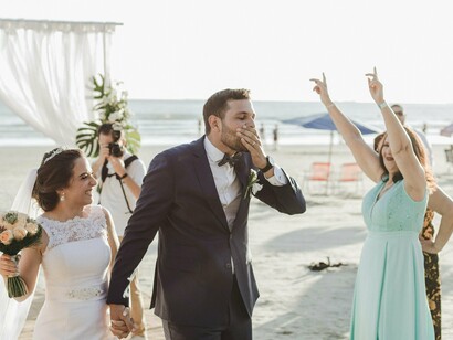 With sand beneath their feet and sunlight in their smiles, this couple kicks off forever in paradise