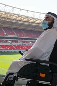 A handicap Arab gentleman in a football stadium waiting for the FIFA World Cup in Qatar to begin