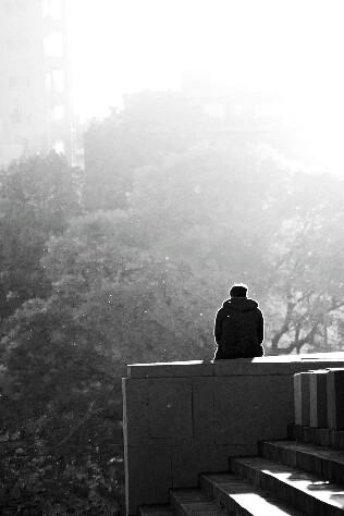 A close view of figure sitting down and reflecting on how actions are influenced by primal instincts 