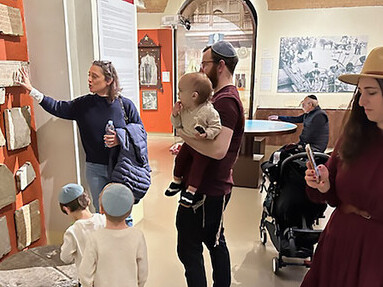 Micaela Pavoncello, explaining (cast copies) of ancient stone epitaphs from the Jewish Catacombs in Rome, Jewish Museum of Rome March 2024, photo by Brenda Lee Bohen, Italy