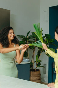 A lively kitchen scene captures the essence of health as two friends supplement their day with omega-3s from natural sources
