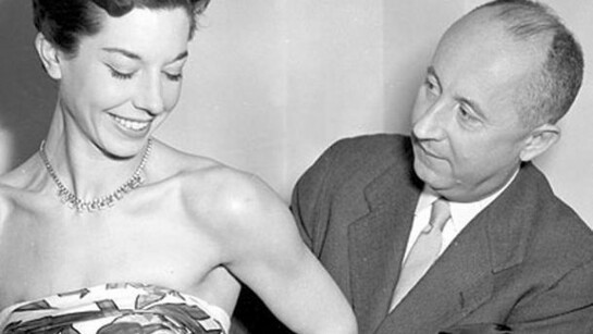 Christian Dior with model Dorothy Emms, 1957, (c) 2004 TopFoto