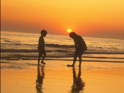 Two kids playing on the beach