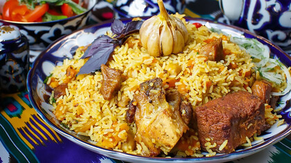 A plate of rice with meat and vegetables