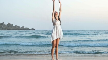 Woman celebrating her accomplishments at the beach