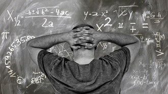 A student staring at the problem on the board at his university, unsure of the answer