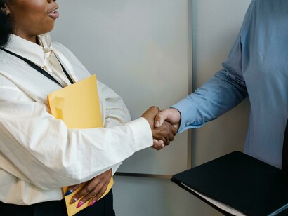 A meaningful handshake between two people from diverse backgrounds following a peacebuilding conversation