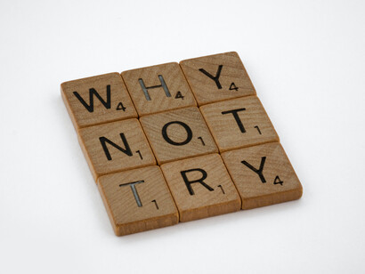 Scrabble pieces arranged to deliver a motivational message to keep trying