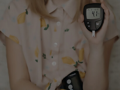 In a poignant moment, a little girl holds a glucometer in her hand, showcasing her resilience and involvement in managing her health
