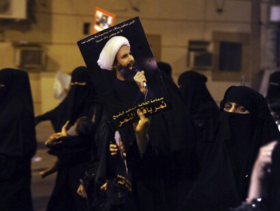 Protester holds picture of Sheikh Nimr-al-Nimr