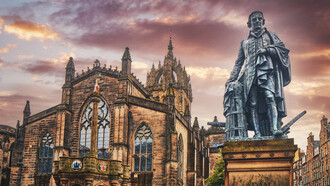 Statue of Adam Smith, widely considered to be the father of economics and capitalism, in front of St. Giles Cathedral on the Royal Mile in Old Town Edinburgh, Scotland 