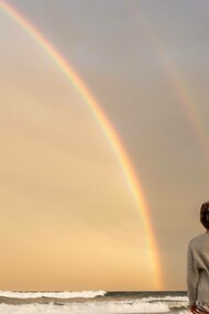 A double rainbow witnessed in solitary on the beach