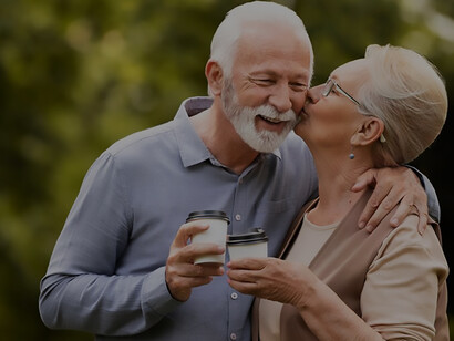 Experience the joy of a happy and healthy senior couple in the park, drinking coffee, symbolizing the essence of healthy brain aging and longevity