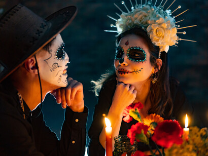 In Mexico, two people dress up on the Day of the Dead, a day of remembrance for loved ones who have gone