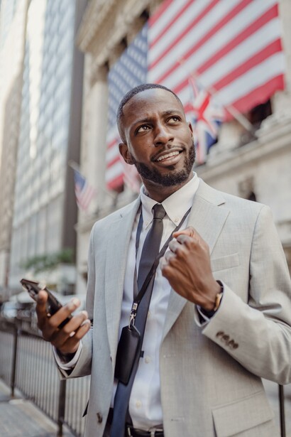 A man cheering for his victory in the business world, after receiving a positive phone call