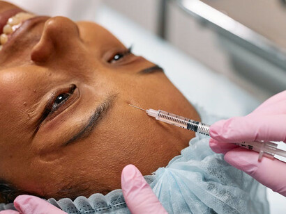 A woman getting botox from a Doctor, a cosmetic procedure