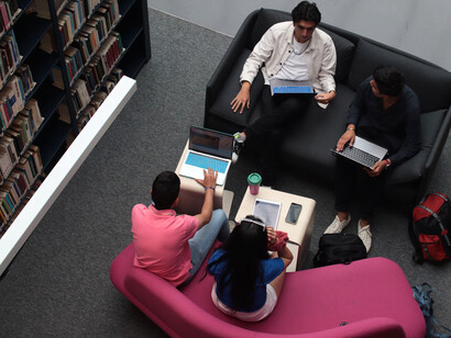 Young people studying and collaborating together, symbolizing the growing importance of education and shared knowledge in the digital age
