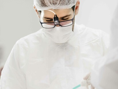 A dentist is in deep concentrating while working on a tooth that needs more attention than anticipated