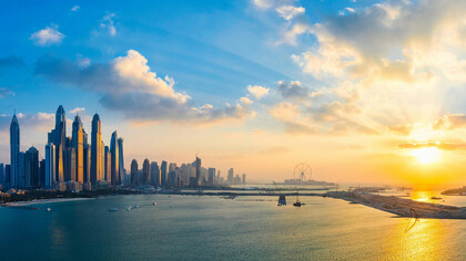 A panoramic view of the Dubai Marina skyline in the United Arab Emirates at sunset. The UAE is a federation of seven emirates: Abu Dhabi (capital), Dubai, Sharjah, Ajman, Umm Al Quwain, Ras Al Khaimah, and Fujairah