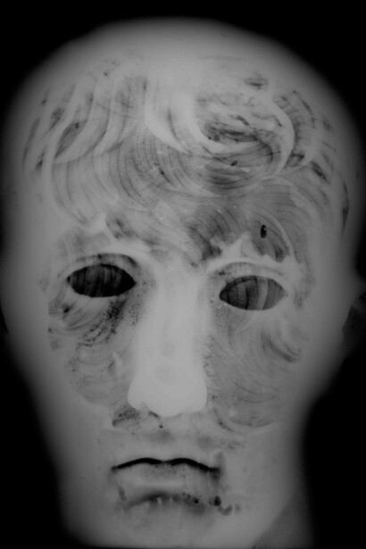 X-ray photograph showing minor impurities in the metal and the outlines of square repair patches. © The Trustees of the British Museum