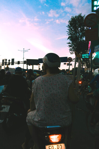 A person riding a scooter along a bustling street in Canggu, Bali, Indonesia