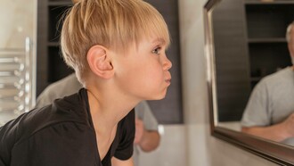 Young boy using mouth wash