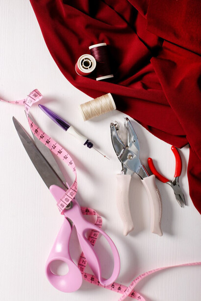 Essential elements for fashion design in the studio: sewing tools and scissors on the table