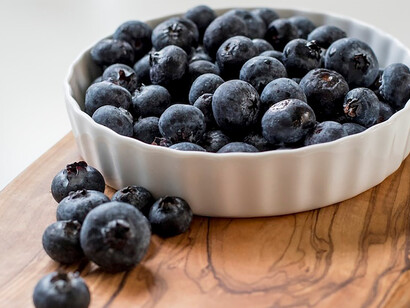 Blackberries placed on a sturdy brown wooden chopping board