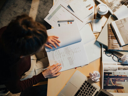 An editor's work desk, filled to the brim with material
