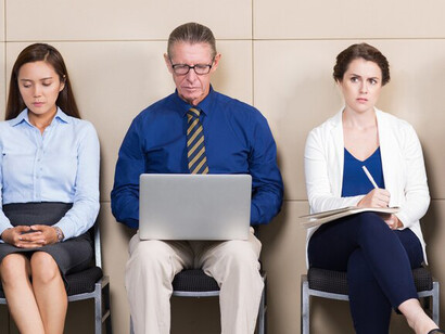 Five applicants waiting in a room, one of whom is an elder