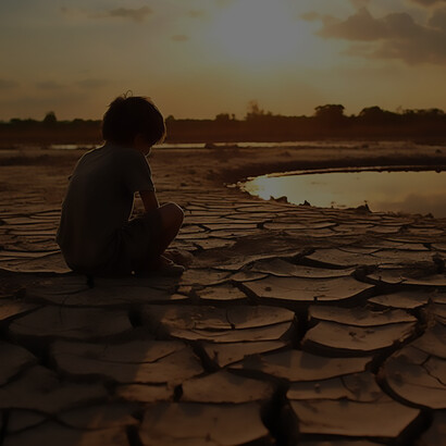 Child staying in landscape of extreme drought