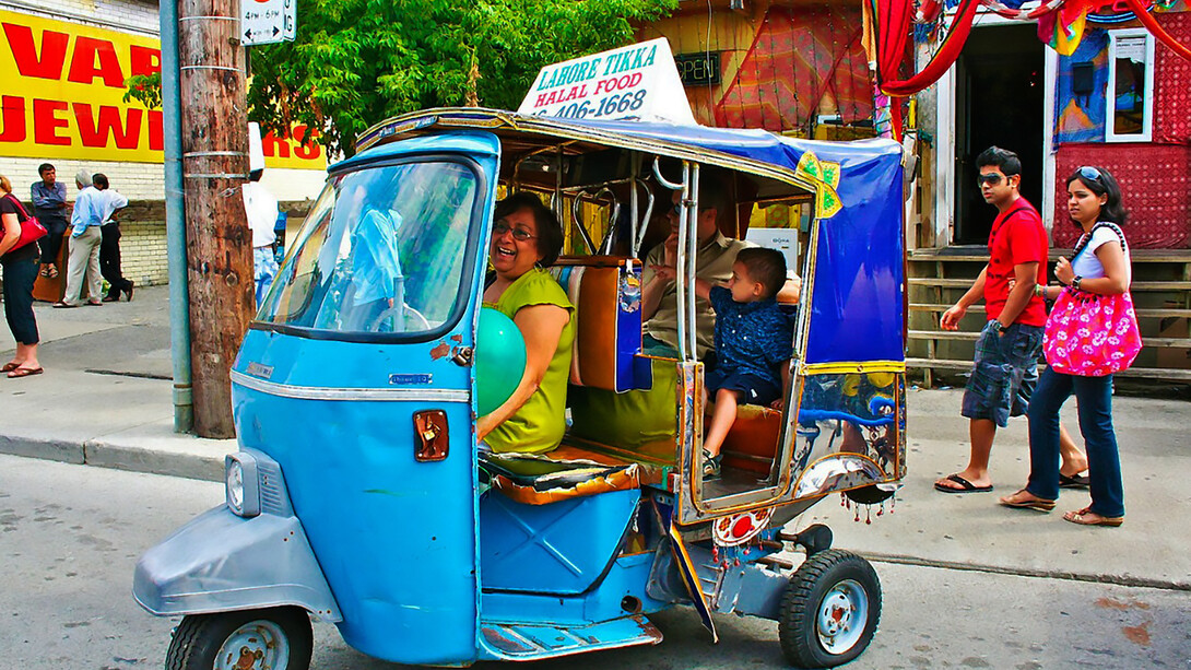 Tourists ride the iconic Tikka Taxi rickshaw through the streets of Lahore, Pakistan