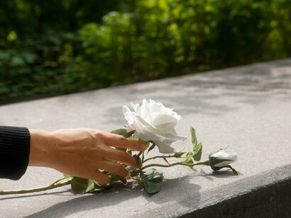 Graveyards are often adorned with white flowers, which symbolize purity and are traditionally used at funerals to honor the deceased