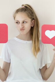 A girl posing with digital “like” symbols, illustrating online validation