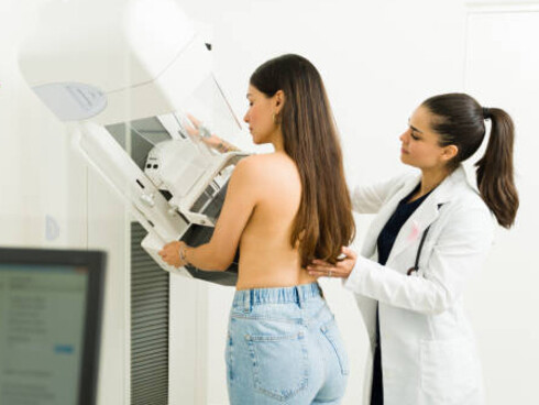 At the imaging center, a patient undergoes a mammography exam, supported by AI technology to enhance breast cancer screening and diagnostic precision