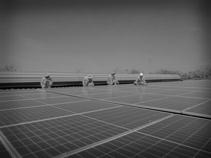 The solar crew works on the installation of large solar panels