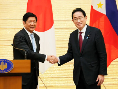 Japanese Prime Minister Fumio Kishida, right, shakes hands with Philippine President Ferdinand Marcos Jr, left, after signing a defensive agreement in Tokyo that aims to boost the military cooperation between the two island nations