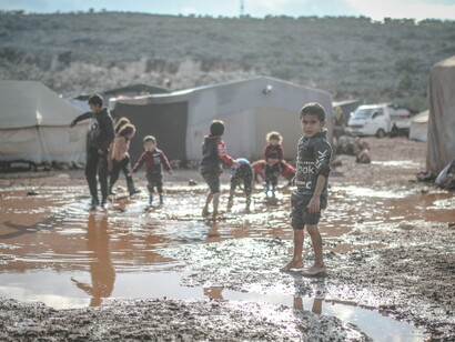 Children playing on a muddy area