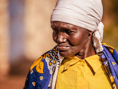 With a gaze that seems to hold the weight of generations, this grandmother reflects on the challenges of poverty, reminding us of the urgent need for meaningful change