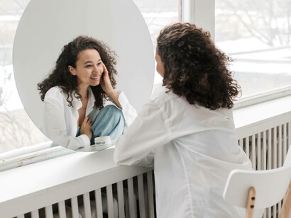 A woman admiring herself as she expresses her self-love openly and without restraint