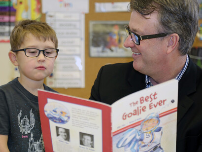 Health and Wellness Minister, Doug Currie, reads with kindergarten student, Lachie Hillier