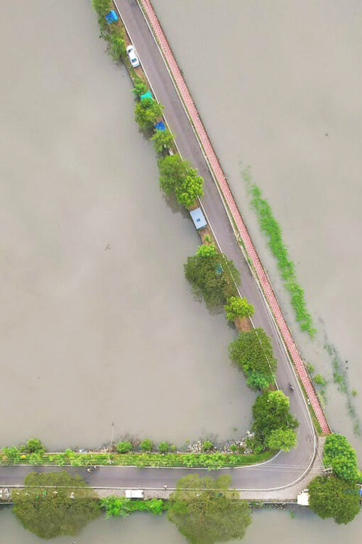 A road submerged in water due to flooding caused by extreme weather events in Kijal, Terengganu, Malaysia