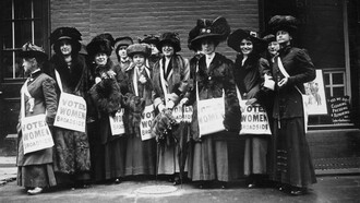 Members of the women's suffrage movement prepare to march on New York's Wall Street in 1913, armed with leaflets and slogans demanding the vote for women