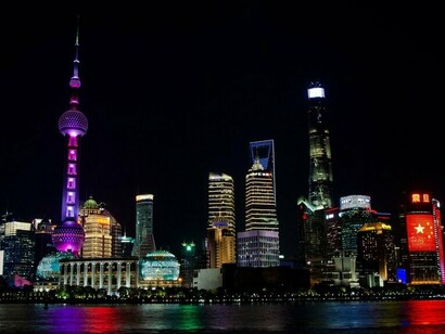 Modern skyscrapers rising above the waterfront in Shanghai, China, symbolizing China's rapid urbanization and technological advancement