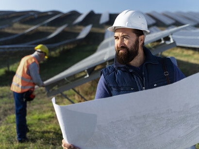 A couple of experts finishing a solar panel farm