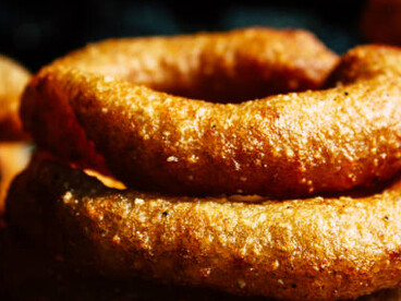 Sel roti is a popular Nepali rice bread known for its crispy texture and its distinctive round shape