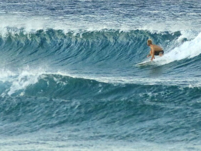 A woman walking on the beautiful sand of Tofo beach in Mozambique