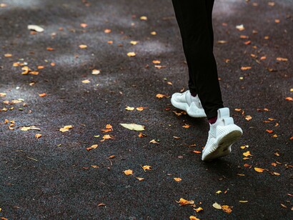 Person walking in the park to clear their mind 