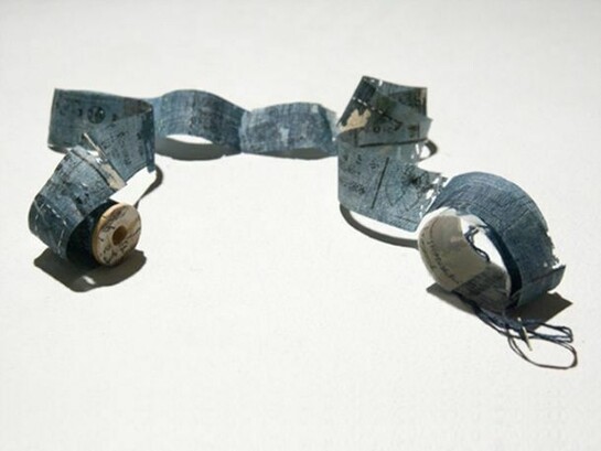Yuko Kimura, Book of Journey through Mushikui no. 6 2011, etching on antique book pages from Japan, linen thread, wooden spool, 1.75 x 1.25 x 37 inches