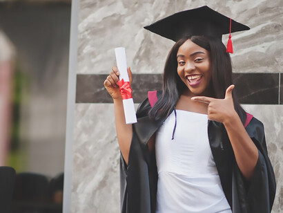 Young female student with diploma poses